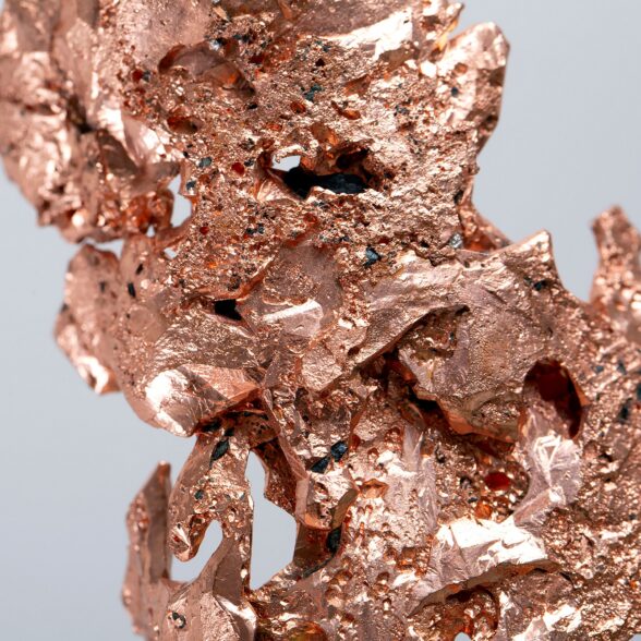 A macro shot of a copper mineral specimen stone rock geology gem crystal with a gray background
